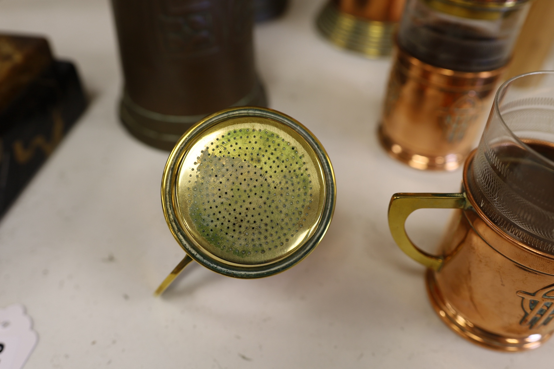 Three Art Nouveau mixed copper and brass coffee pots and two individual copper filter coffee glasses, tallest 36cm high (5). Condition - two pots need cleaning, but good condition for age